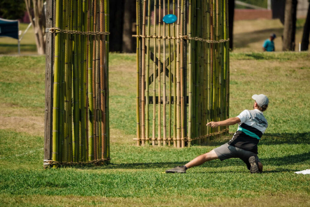 Disc golfer throwing through triple mando at USDGC